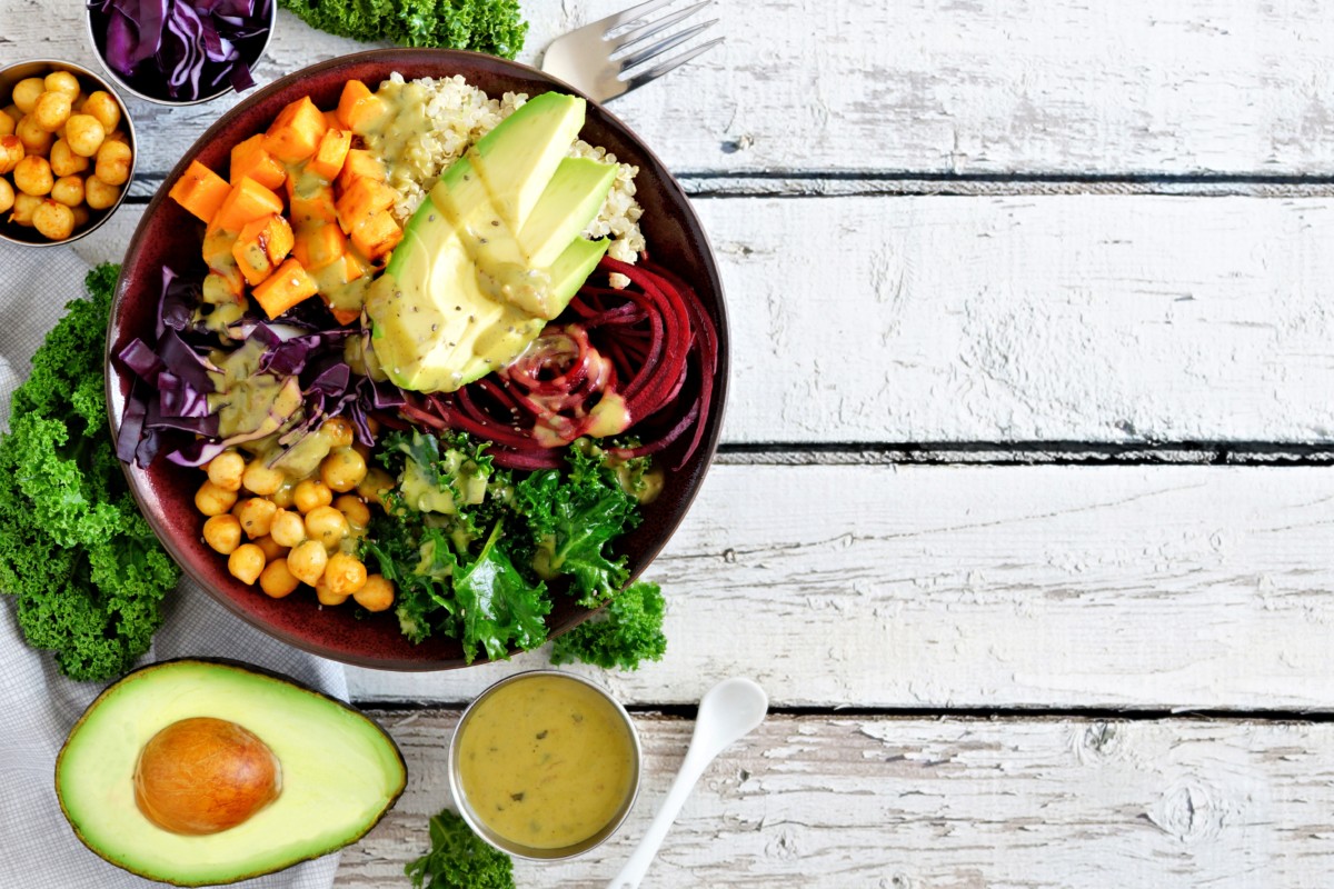 Buddha bowl with quinoa, avocado, chickpeas, vegetables on a white wood ...
